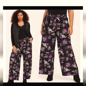 Black, purple and gray flowered pants.